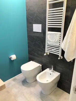 a bathroom with a white toilet and a sink at Residenza De Gasperi in Palermo