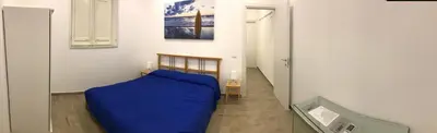 a bedroom with a bed with a blue blanket at Casa Saline in Mondello