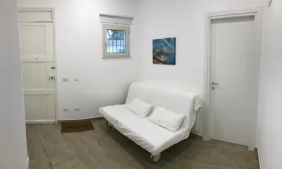 a white couch with two pillows on it in a room at Casa Saline in Mondello