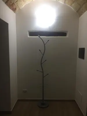 a light in a room with a sculpture of a tree at Casa Vacanza La Pergola in Terrasini