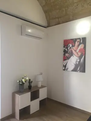 a living room with a painting on the wall at Casa Vacanze La Pergola@ in Terrasini