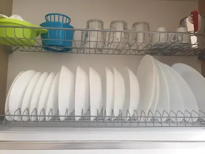 a refrigerator shelf filled with plates and utensils at Casa Vacanze La Pergola@ in Terrasini