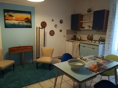 a kitchen with a table and chairs in a room at casa in palazzo Graffeo Eva in Palermo