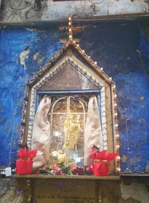 a shrine with a window with red roses on it at Stranizza d'amuri, al Capo vero cuore di Palermo vedi anche atocà1 in Palermo
