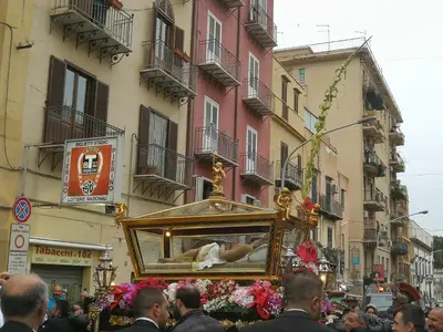 a crowd of people walking down a street with a float at Stranizza d'amuri, al Capo vero cuore di Palermo vedi anche atocà1 in Palermo