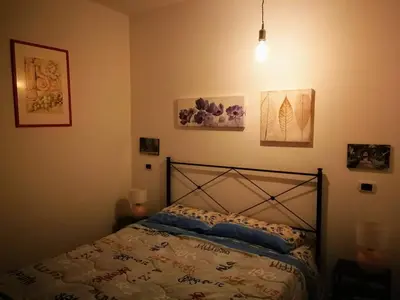 a bedroom with a bed and some pictures on the wall at Stranizza d'amuri, al Capo vero cuore di Palermo vedi anche atocà1 in Palermo