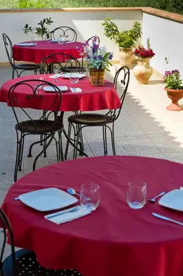 two red tables with plates and napkins on them at Al Cantuccio in Castelluzzo