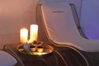 a table with candles and a bed with a tray of food at Quintocanto Hotel & Spa in Palermo