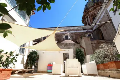 a group of chairs in front of a building at Quintocanto Hotel & Spa in Palermo