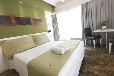 a hotel room with a bed and a desk at Quintocanto Hotel & Spa in Palermo