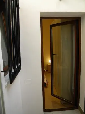 a mirror on a wall next to a hallway at La Casetta del Viale 13 in Palermo