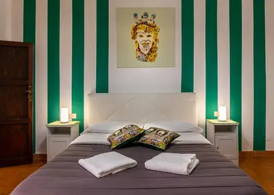 a bedroom with a bed with two pillows on it at La Casa del Moro in Palermo