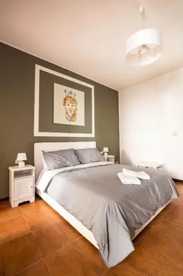 a bedroom with a large bed and two night stands at La Casa del Moro in Palermo