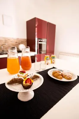 two plates of food on a kitchen counter with orange juice at La Casa del Moro in Palermo