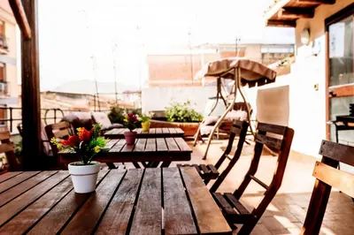 a wooden table and chairs on a patio at La Casa del Moro in Palermo