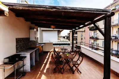 a patio with a table and chairs on a balcony at La Casa del Moro in Palermo
