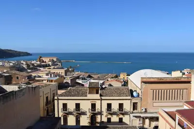 a view of a city with the ocean in the background at Casa Vacanza Mar' illù in Castellammare del Golfo