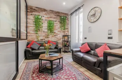 a living room with two leather couches and a table at Panurban Rooms by Wonderful Italy in Palermo