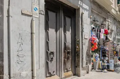 a store door with a sign on the side of a building at Panurban Rooms by Wonderful Italy in Palermo