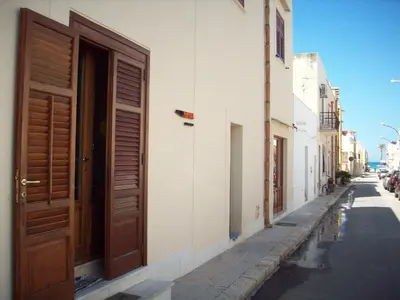 a door on the side of a building on a street at Angolo Arancio Bed & Breakfast in San Vito lo Capo