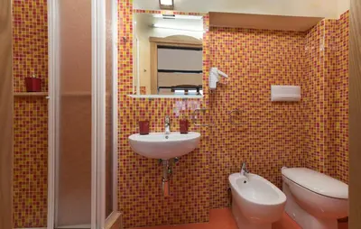 a bathroom with a sink and a toilet and a mirror at Angolo Arancio Bed & Breakfast in San Vito lo Capo