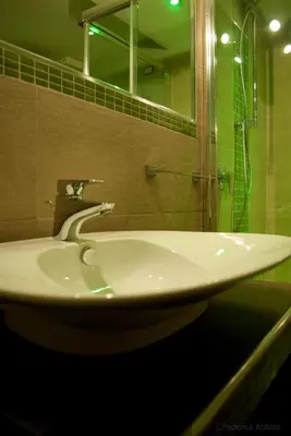 a bathroom sink with a shower and a mirror at Affittacamere B&B Carella in Palermo