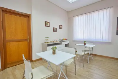a room with two tables and chairs and a door at Sturzo 44 in Palermo