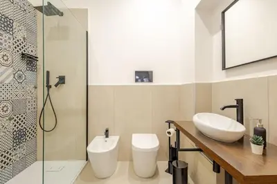 a bathroom with a toilet and a sink and a shower at Alle Antiche Mura del mercato di Ballarò in Palermo