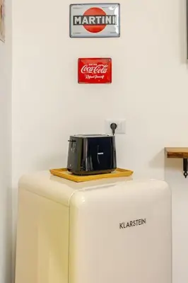 a toaster sitting on top of a refrigerator at Alle Antiche Mura del mercato di Ballarò in Palermo
