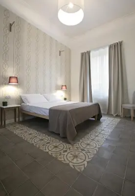 a bedroom with a bed and two lamps in it at Bed in Spa in Palermo