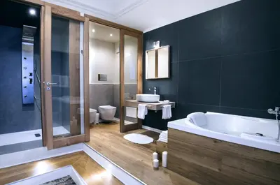 a bathroom with a tub and a toilet and a sink at Bed in Spa in Palermo