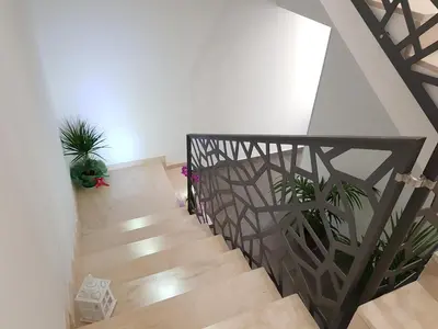 a staircase with potted plants in a room at L'Angolo Dello Zio in San Vito lo Capo