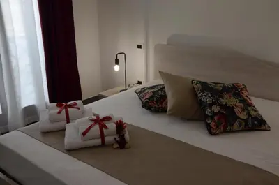 a bed with two towels and presents on it at L'Angolo Dello Zio in San Vito lo Capo