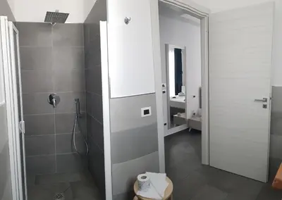 a bathroom with a shower with a toilet and a sink at L'Angolo Dello Zio in San Vito lo Capo