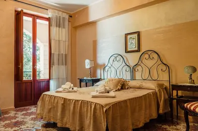a bedroom with a bed with towels on it at B&B Elvira Al Duomo in Monreale
