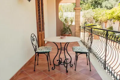 a table and two chairs on a balcony at B&B Elvira Al Duomo in Monreale