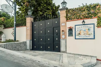 a gate to a house with a sign on it at B&B Elvira Al Duomo in Monreale