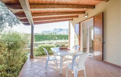 a white table and chairs on a patio at Casa Giuseppa in Mandra Capreria