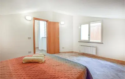 a bedroom with a large bed and a window at Casa Giuseppa in Mandra Capreria