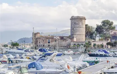 a bunch of boats in a harbor with a castle at Casa Giuseppa in Mandra Capreria