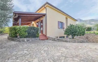 a house with a stone driveway in front of it at Casa Giuseppa in Mandra Capreria
