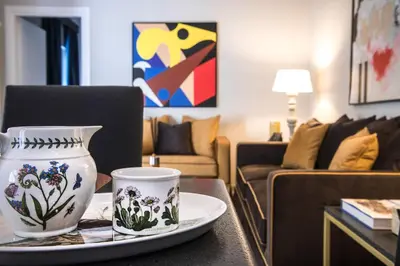a living room with a vase and a plate on a table at A&G Dimore di Famiglia - Un Lusso Garbato in Palermo