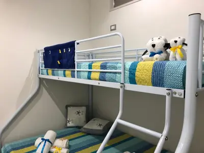 a bunk bed with stuffed animals on the top bunk at BENVENUTI AL SUD in Castellammare del Golfo