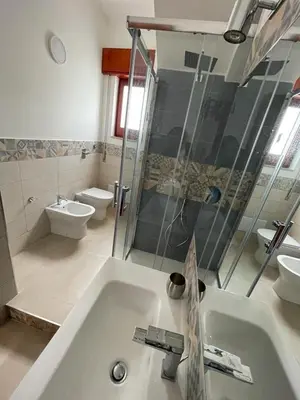a bathroom with a sink and a shower and a toilet at Sul lungo mare posizione unica in San Vito lo Capo
