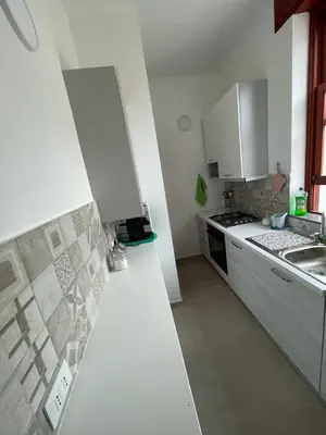 a kitchen with white cabinets and a white counter top at Sul lungo mare posizione unica in San Vito lo Capo