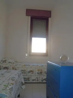 a bedroom with a window and a bed and a dresser at Sul lungo mare posizione unica in San Vito lo Capo