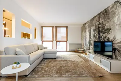 a living room with a couch and a tv at Solemar Sicilia - Galleria Maqueda in Palermo