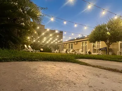 a house with chairs and lights in the yard at Amantea Monument in Terrasini