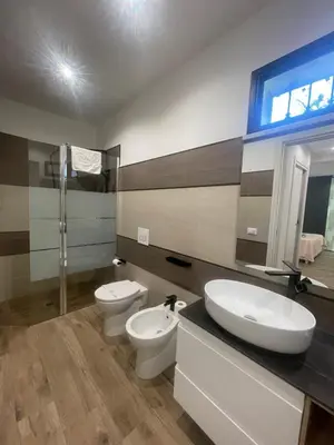 a bathroom with two toilets and a sink at Amantea Monument in Terrasini