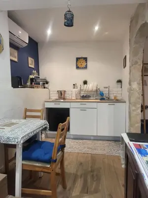 a kitchen with a table and chairs in a room at Il Rifugio in Palermo